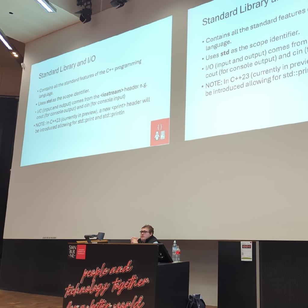 Photo showing club president presenting workshop on stage.