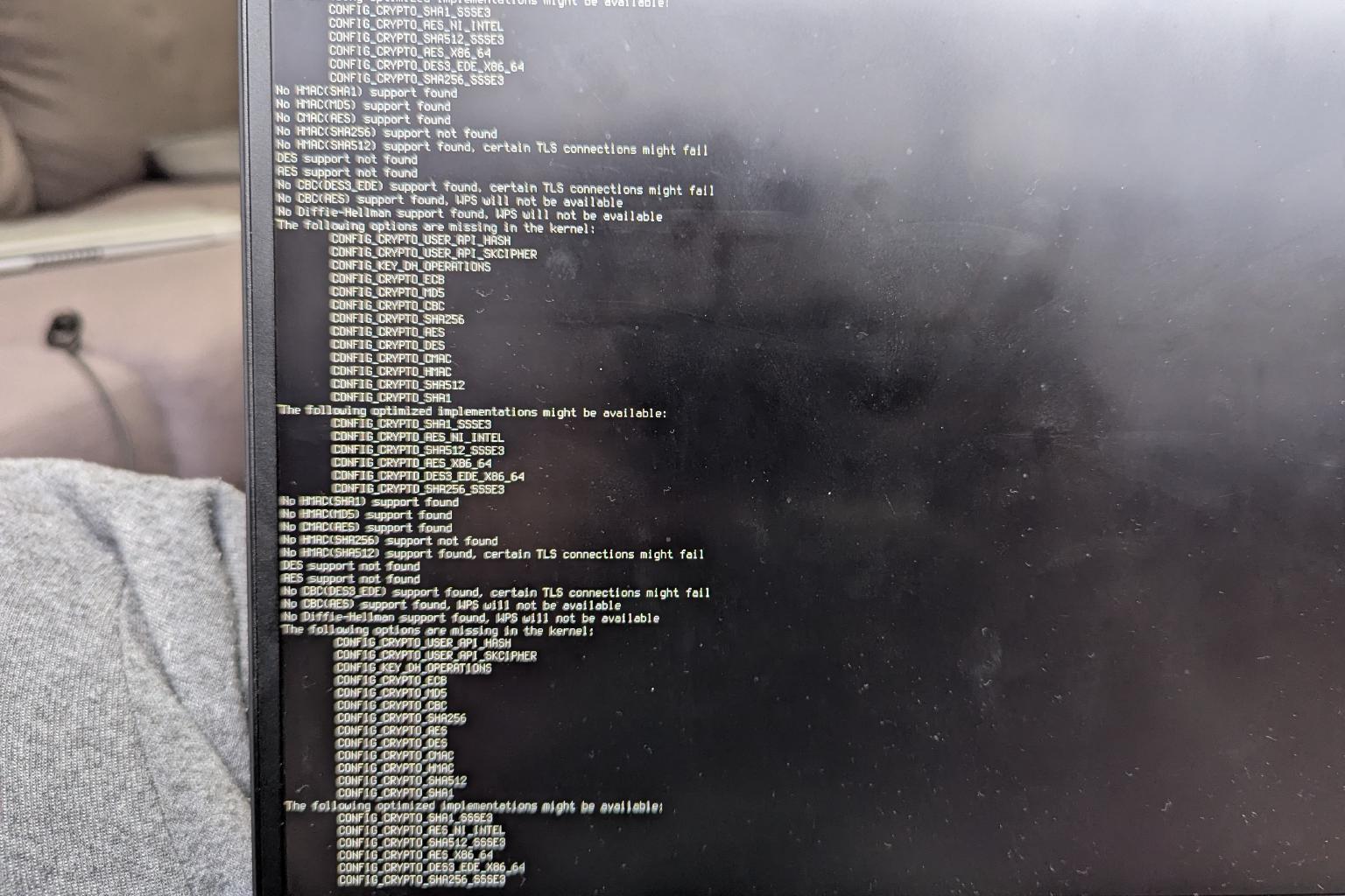 Photo taken of Linux terminal displaying iwd configuration errors.